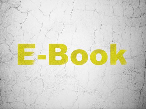 Studying concept: Yellow E-Book on textured concrete wall background