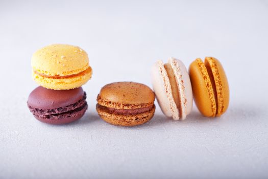 Colorful almond cookies macaroons on a white surface