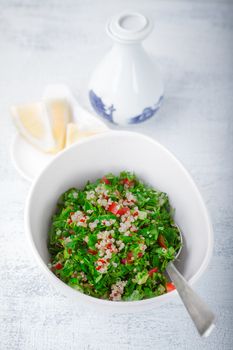 Quinoa tabbouleh salad on a wooden table.