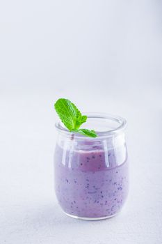 Delicious blueberry yoghurt smoothie on a white background