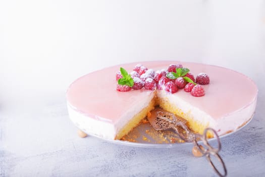 Raspberry yogurt cake with berries on a table