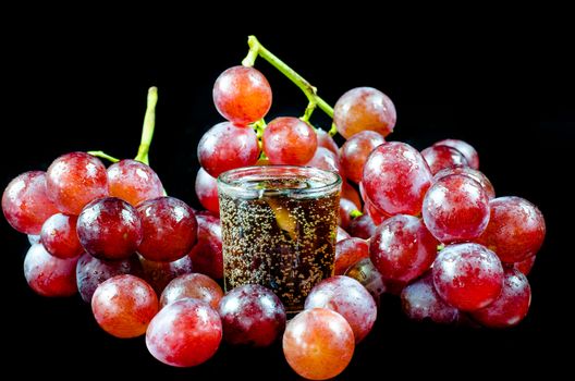 glass of wine red grape isolated on black background