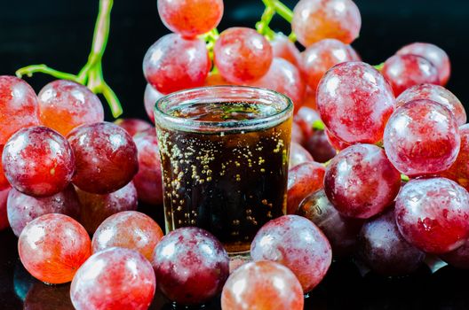 glass of wine red grape isolated on black background