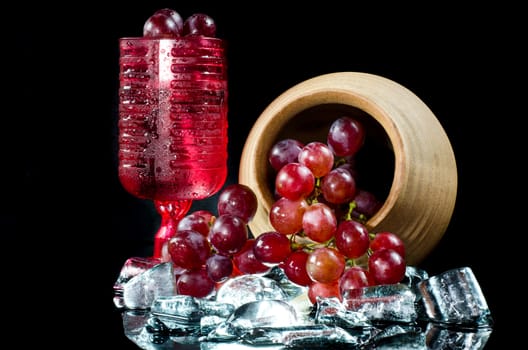 Grape glasses  red wine  closeup a black background.