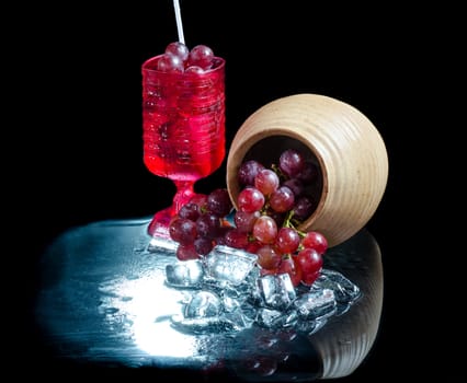 Grape glasses  red wine  closeup a black background.