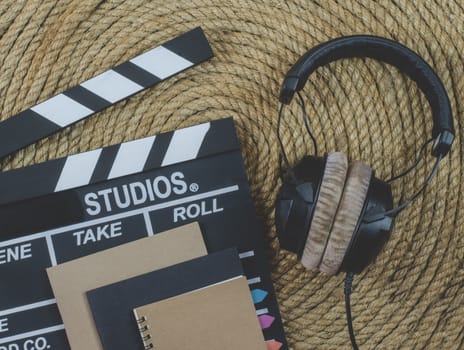 notebook and headphone music  on a jute rope background