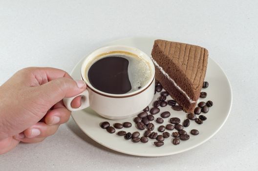 A cup of coffee with slice of chocolate cake on White background