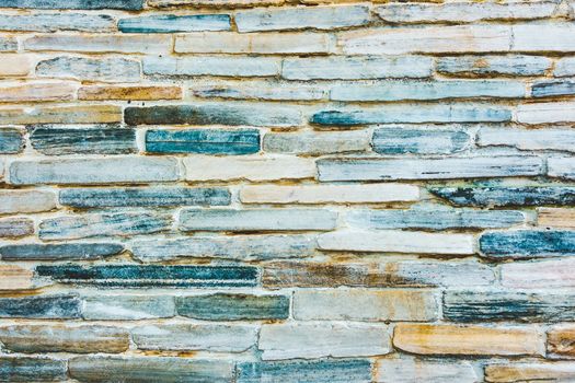 Stone wall texture with blue and orange hue