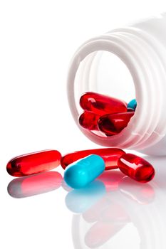 Container with pills close-up on a white background