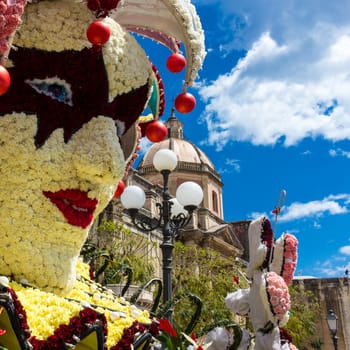 flowered mask with carnations and roses to celebrate the Sicilian spring