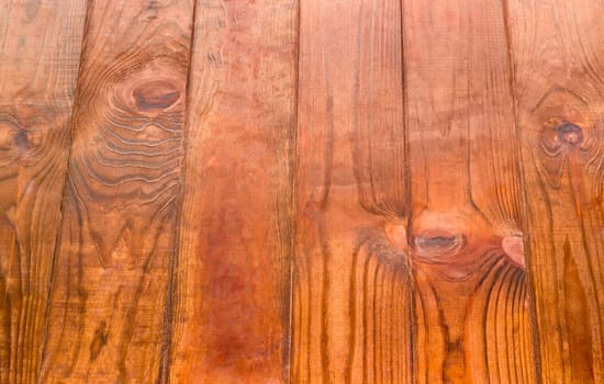 Background of the surface consisting of the several old dark-colored wooden planks
