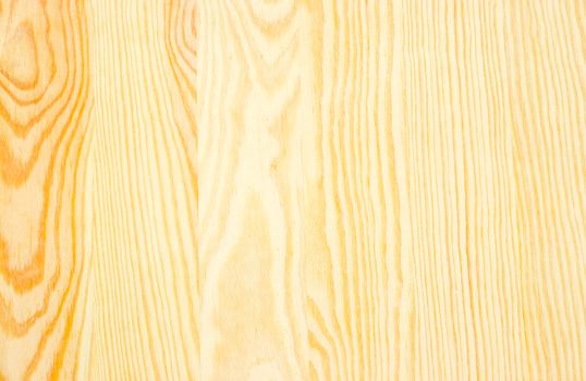 Background of the light-colored wooden surface made of the several pine planks
