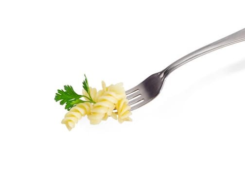 Some cooked spiral pasta and small parsley twig on the stainless steel fork closeup on a light background
