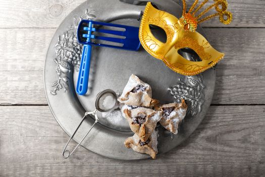 Jewish Pastry Hamantaschen with a mask for Purim Holiday