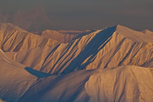 Snow peaks of the mountains in the evening