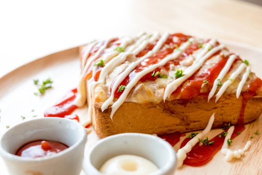 Pizza toasted bread with tomato sauce and ham cheese selective focus.