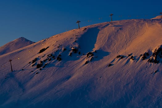 Snow peaks of the mountains in the evening