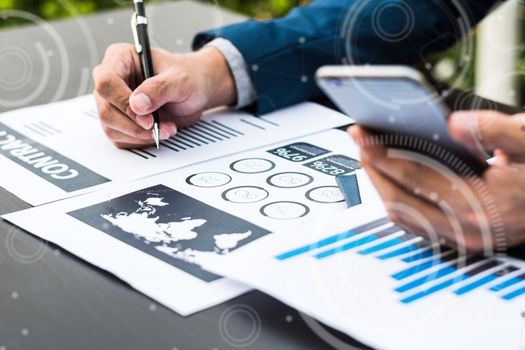 Handsome businessman wearing suit and using modern laptop outdoors and graph finance diagram,