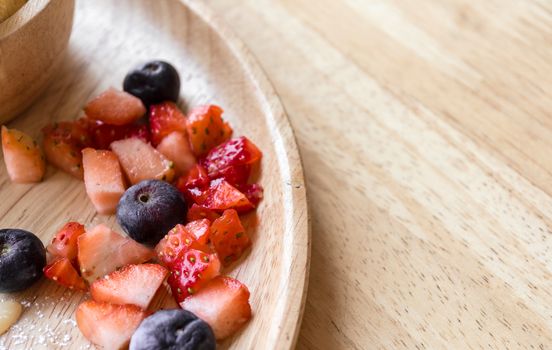 fresh dessert soft vanila roti with ice cream ,syrup ,strawberry and blueberry on plate in restaurant ,selective focus