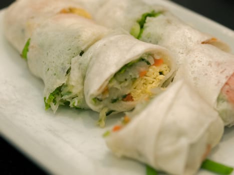 VEGETABLE SPRING ROLLS ON WHITE PLATE