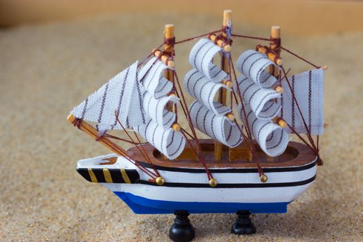 toy of a sailing ship in a sand