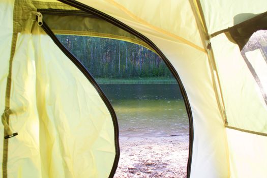 view from a green tent. lake and forest