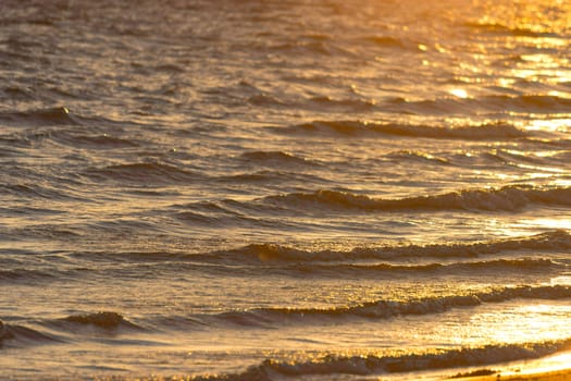 sun reflection on ocean waves. close up background
