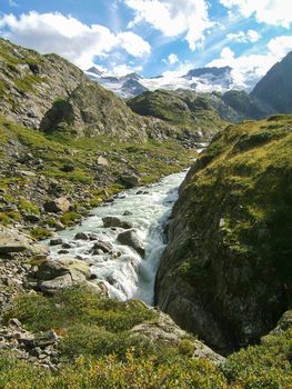 alpine mountain water stream in the mountain of Switzerland on a sunny day