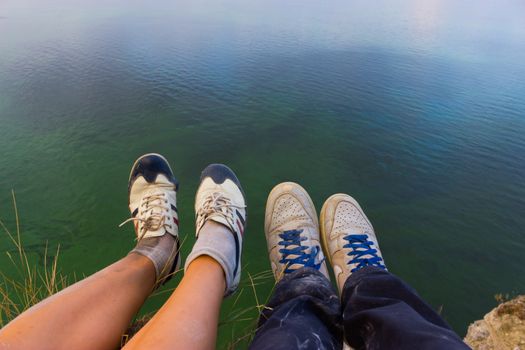 Feet hanging in the air. above the sea