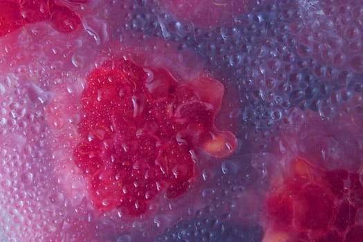 raspberries in a box with water drops