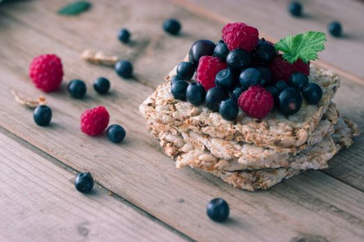 Bread topped with fresh fruit and mint leaf