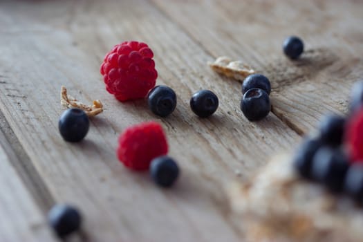 raspberry and blueberry on a wooden table
