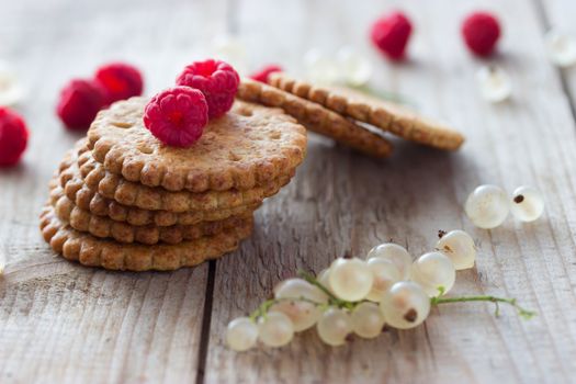 cookie and fresh raspberry on wooden background