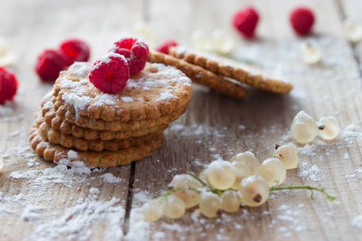 cookie and fresh raspberry on wooden background