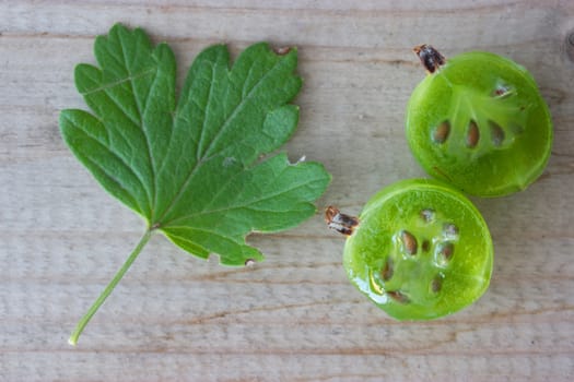half of a gooseberry on wooden table