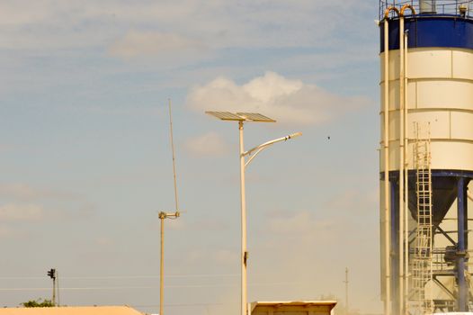 Silos with voltaic panel lighting and a radio antenna in central Kenya