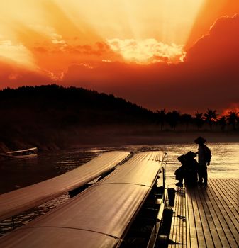 Taxi boats that use in Thailand on Khwae Yai river. Mooring at sunset