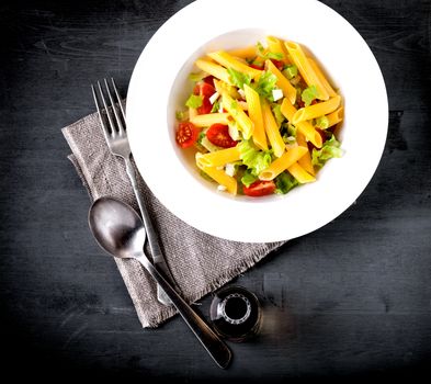 Pasta salad with fresh greenery and tomatos