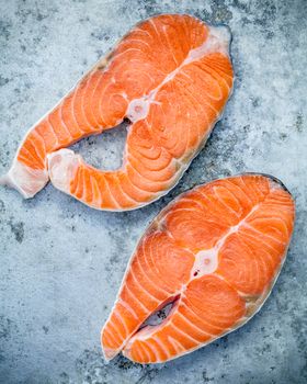 Fresh salmon fillet sliced flat lay on shabby metal background. Fresh salmon fillet sliced tempts buyers at fresh seafood stall.