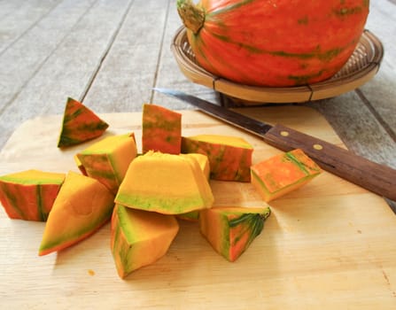 Pumpkin on the chopping block in preparation for cooking.