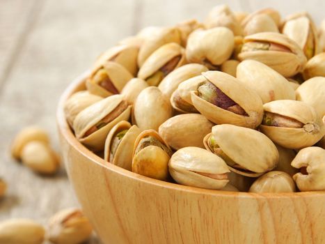 Pistachio nuts in wood cup ,closeup