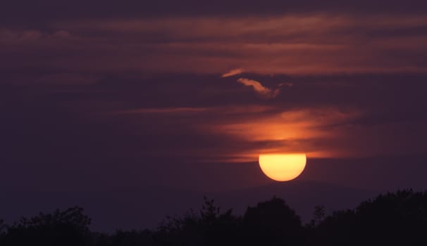 Bright big sun on the sky with clouds