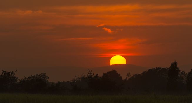 Bright big sun on the sky with clouds