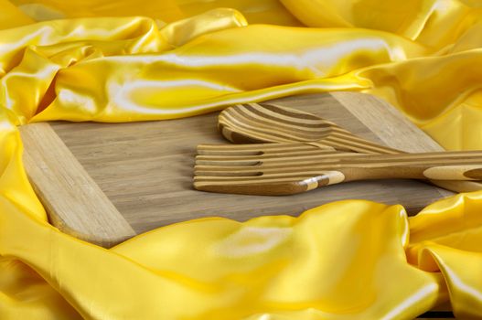 a cutlery and a bamboo cutting board