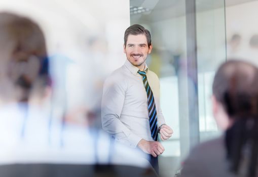 Relaxed cheerful team leader and business owner leading informal in-house business meeting. Business and entrepreneurship concept.