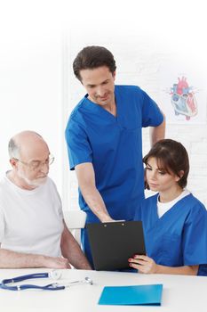 Happy senior patient and doctors in hospital