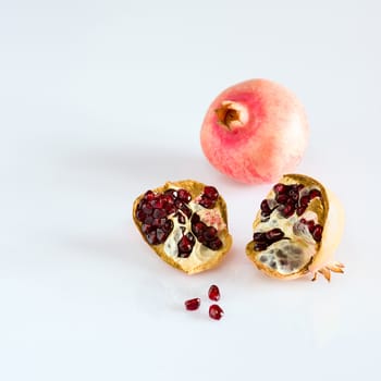 Juicy pomegranate fruits on white background