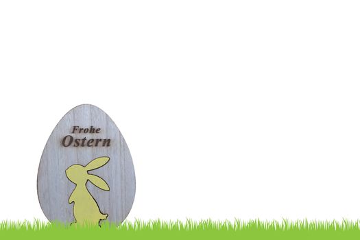 Grass and wooden egg with bunny and german text for happy easter