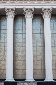 Architectural white columns on the facade of the building.