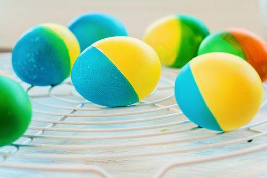 Easter eggs painted by hand yellow and blue lie on lattice